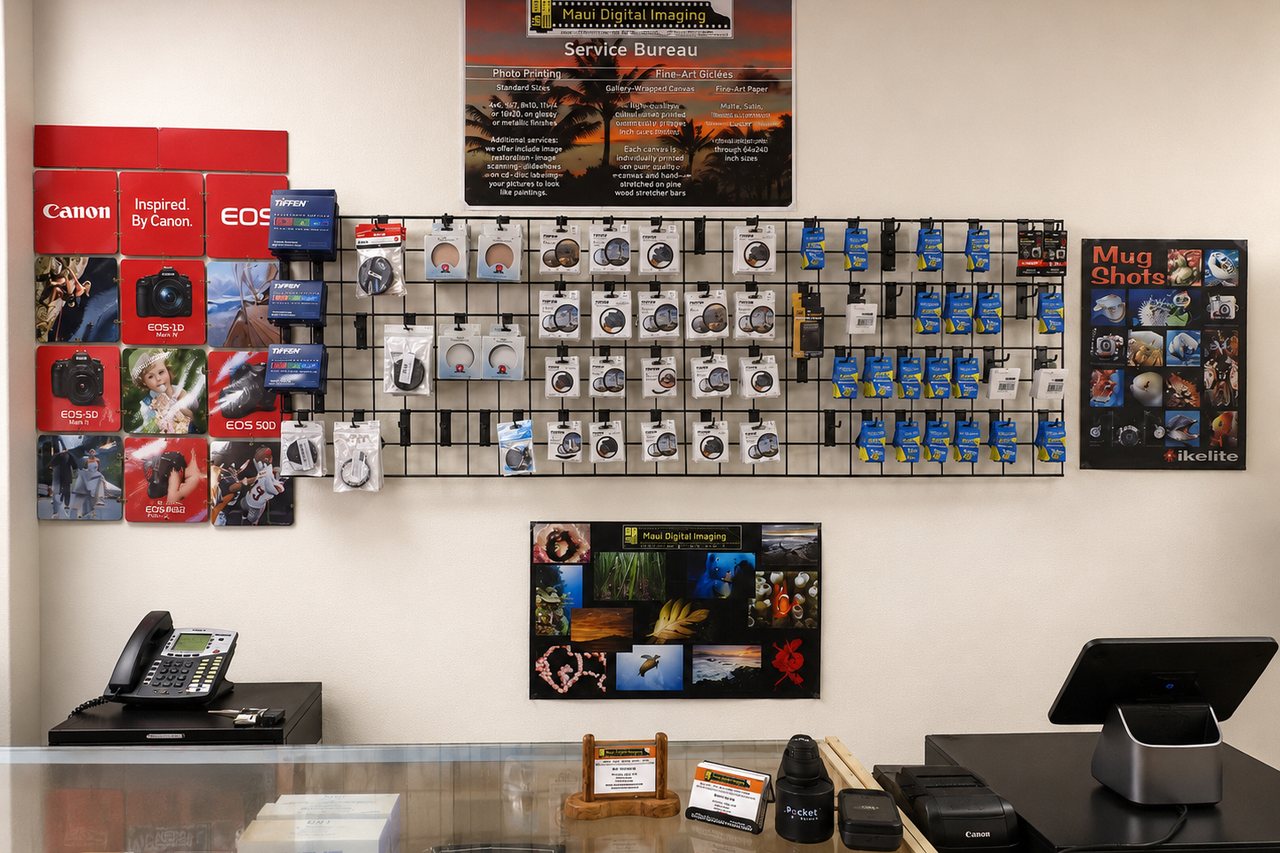 The camera accessory wall at Maui Digital Imaging, stocked with filters, batteries, memory cards and underwater photography gear.