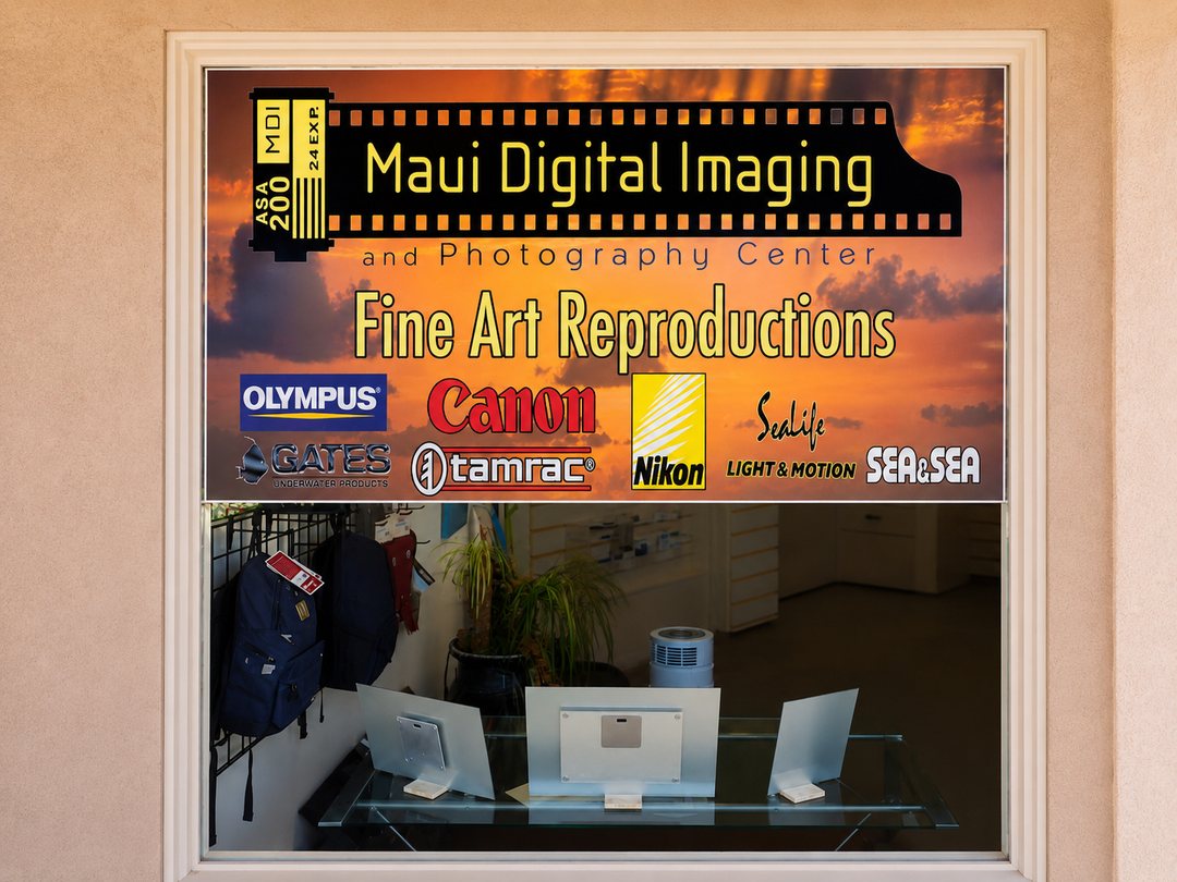 The Maui Digital Imaging storefront window, with the film-strip logo and a Fine Art Reproductions sign.